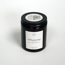 Load image into Gallery viewer, 'Old Bookshop' book scented soy candle in amber jar with black lid and illustration. The perfect book lover gift for readers. Handmade vegan, soy candle by Wick + Wonder.